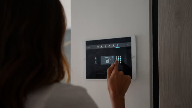 Woman using smart home security control